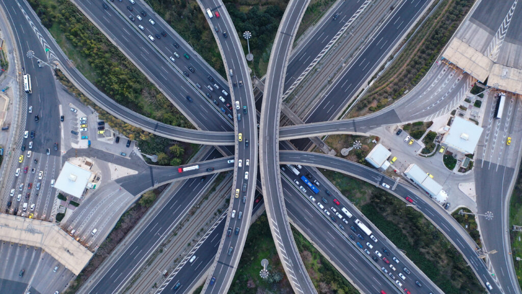 A multilevel junction highway overpass with various vehicles from above.
