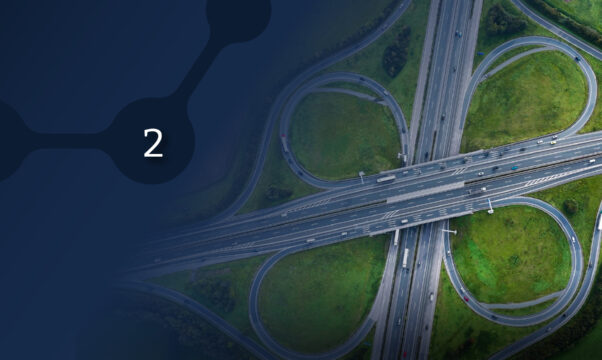 An aerial view of a complex highway cloverleaf interchange with a dark blue overlay on the left side containing the number 2.